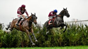 Gloucestershire , United Kingdom - 16 March 2022; Tiger Roll, with Davy Russell up, left, leads the eventual winner Delta Work, with Jack Kennedy up, right, over the last during the Glenfarclas Cross Country Chase on day two of the Cheltenham Racing Festival at Prestbury Park in Cheltenham, England. (Photo By David Fitzgerald/Sportsfile via Getty Images)