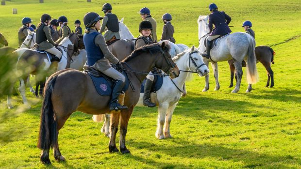 Children waiting for hunt on ponies, dressed in full riding kit