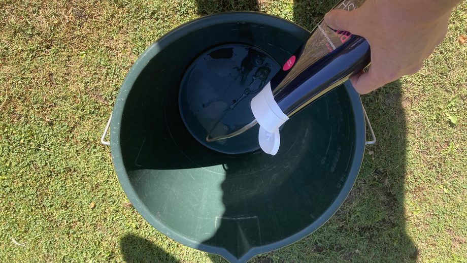 Putting shampoo in bucket