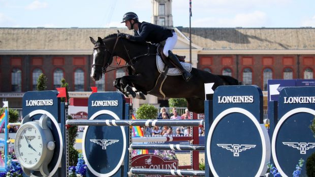 Gilles Thomas and Feromas Van Beek Z jump a fence in front of Chelsea Hospital at the London LGCT