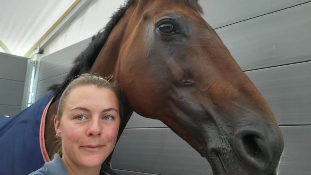 Amy Phillips, groom to Piggy March, with Vanir Kamira in the stables at Burghley 2022