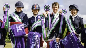 The winning British team at the home leg of the 2022 FEI Eventing Nations Cup series at Houghton. The competition moves to Chatsworth in the 2023 British Eventing calendar. Image shows riders on the podium, holding winning rugs and rosettes.