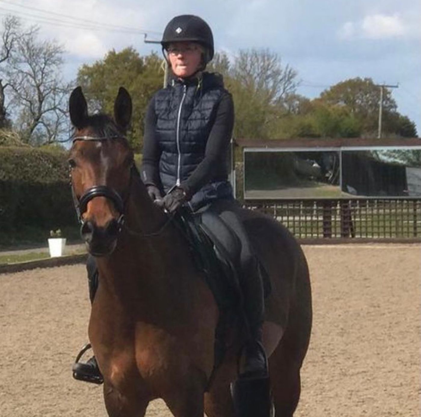 Claire Holliday and Frankie, standing in an all-weather arena