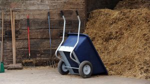 Wheelbarrow upturned at a muckheap