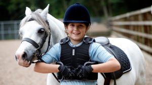 Child wearing Harry Hall body protector with pony