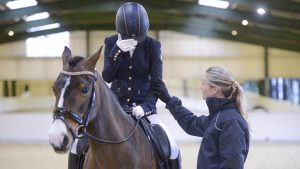 Rider nerves: rider with head in hands in competition