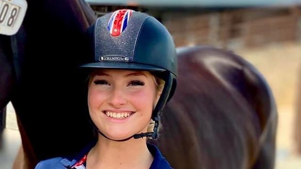 British rider Izzy Palmer, pictured holding a dark bay horse