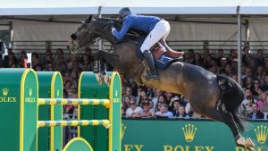 Martin Fuchs and Conner Jei take a flier at the last fence to win the Rolex grand prix at Royal Windsor