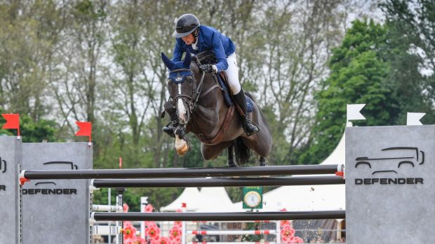 Martin Fuchs and Viper Z jump the Defender fence at Royal Windsor Horse Show 2023