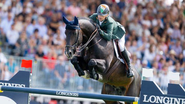 Ireland's Denis Lynch and Vistogrand jump a fence at the European Showjumping Championships in Milan, Italy.