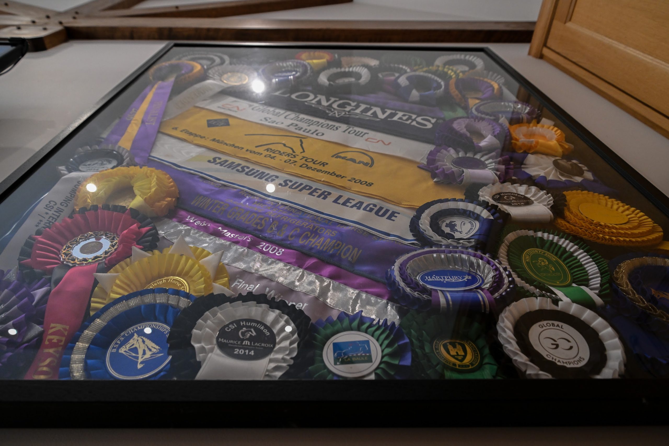 An assortment of ribbons and sashes at Tim Gredley's stables in Unex House near Newmarket in Suffolk