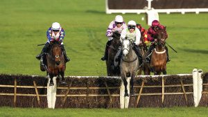 Lossiemouth (pink) clears the last to win The Unibet Hurdle at Cheltenham Trials Day 2024