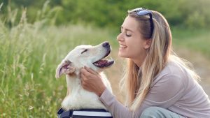 Owner looking at dog and wondering how to know if their dog loves them