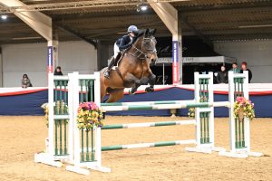 Rosie Smith, daughter of Olympic showjumper Holly Smith, wins the children-on-horses final at the BS Spring Championships riding Azolette, finishing second on Fruselli.