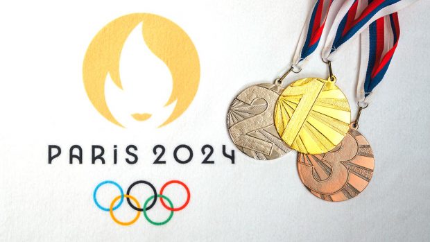 The Paris 2024 Olympic logo overlaid with gold, silver and bronze medals on ribbons