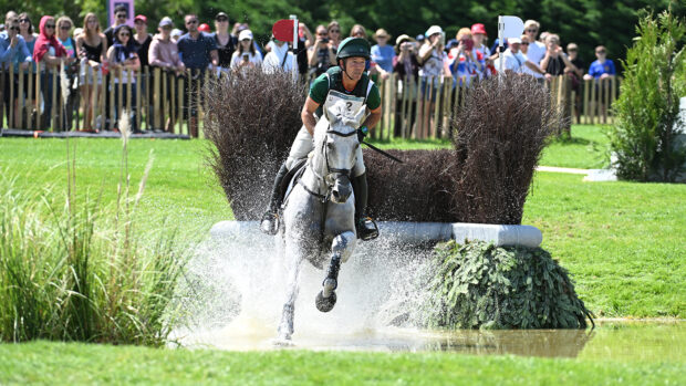 Burghley Horse Trials riders include Austin O’Connor, pictured cantering Colorado Blue through the water after jumping a brush fence at the Paris Olympics.
