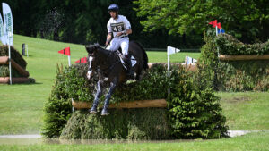 Bramham Horse Trials tickets Harry Meade and Annaghmore Valoner jump. brush fence in the water at Bramham 2024.