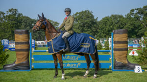 Michael Jackson and Oscar stand proudly wearing their Dubarry Burghley Young Event Horse winners rug in front of the Dubarry jump after winning the five-year-old final.