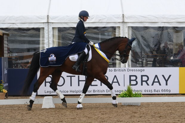 Fiona Maynard riding Denver in trot in the prize giving with his sash, rosette and winner’s rug at the national dressage championships.