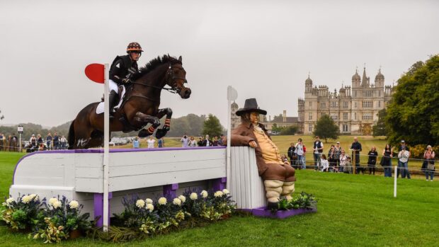 Tom Bird and Cowling Hot Gossip jump Lambert’s Sofa at Burghley 2024 with Burghley House in the background.