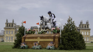 Laura Collett and Hester jump a cross-country fence in front of Blenheim Palace.