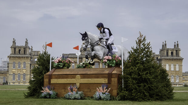 Laura Collett and Hester jump a cross-country fence in front of Blenheim Palace.