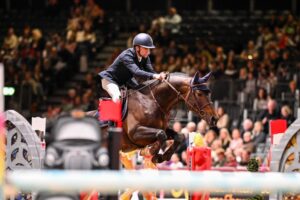 Wilm Vermeir and home-bred stallion Top Invest 313 Z win the Ivy Stakes at the London International Horse Show on the opening day of showjumping, despite power blackouts.