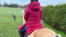 Pikeur Renee Rain Coat on horse from rear