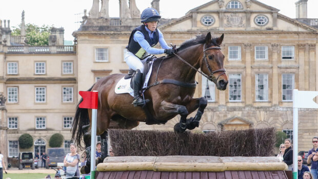 Ros Canter jumping a cross-country fence in front of Badminton House at Badminton Horse Trials