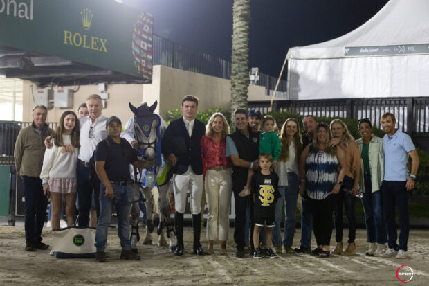 Showjumping news - Tim Brennan of Ireland is surrounded by his visiting family after winning the under-25 grand prix at WEF.
