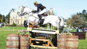 Tom Rowland and Dreamliner clear a table on the cross-country at Thoresby with the house behind.
