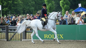 ClareFitch and grey Arab gelding Aja Guiliano canter out of the ring victorious at Royal Windsor