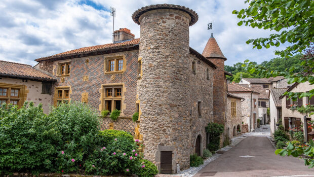A round town on the corner of a traditional stone building in the village of Le Crozet in the Loire region of France, which is hosting the 2025 European Dressage Championships.