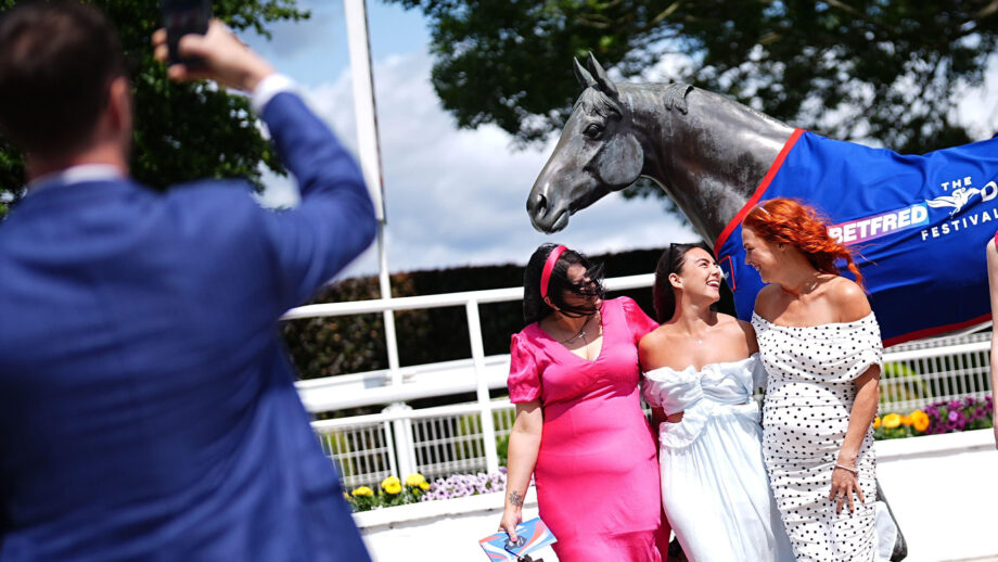 Racegoers having their photo taken at Epsom Downs Racecourse on Ladies Day