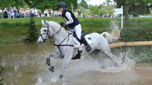Heartbreaker Star Quality and Libby Seed splash through the pond after jumping the angled brush on the Badminton cross-country course 2025.