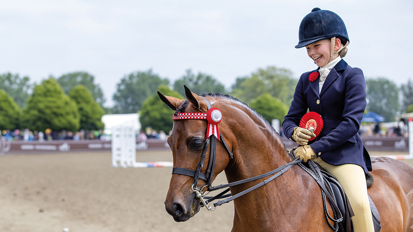 Izzy Walker is full of smiles after Stoneleigh Showtime is crowned show pony champion at Royal Windsor Horse Show