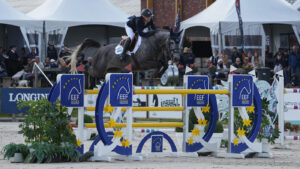 Millie Allen and Clearround Il Mondo Z jump a yellow oxer in the Nations Cup competition at Peelbergen in the Netherlands.
