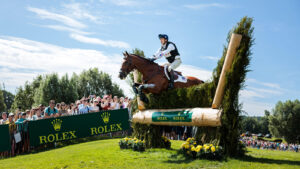 Will Coleman and Off The Record jump a hanging log with brush at CHIO Aachen 2025.