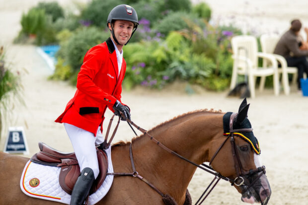 Gilles Thomas of Belgium celebrates winning team gold on Ermitage Kalone.