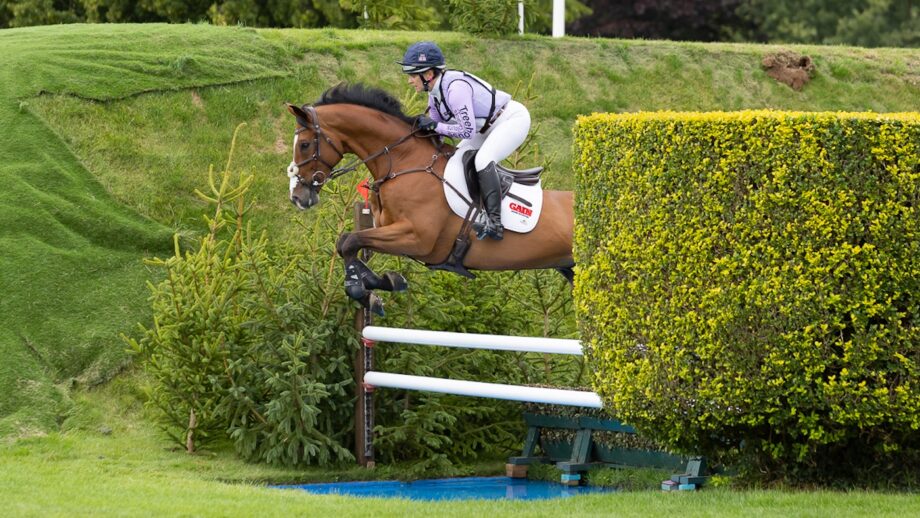 Gemma Stevens and Cooley Park Muze clear white rails over a blue open water ditch at Hickstead.