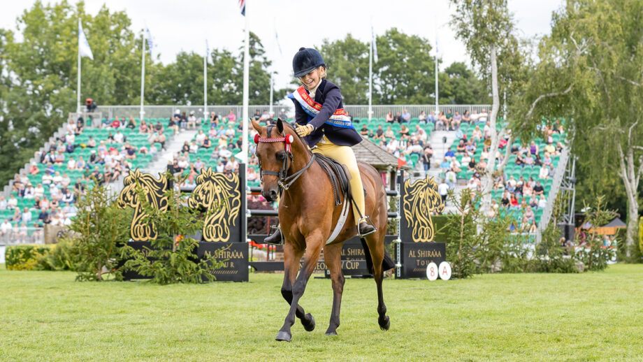 Show pony Stoneleigh Showtime and Izzy Walker trot out of the International Arena victorious having stood supreme ridden pony.