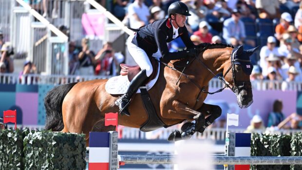 Ben Maher and Dallas Vegas Batilly clear at fence in front of the Paris Olympic crowds.