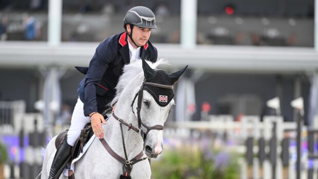 Donald Whitaker gently pats his grey horse Millfield Colette on the neck.
