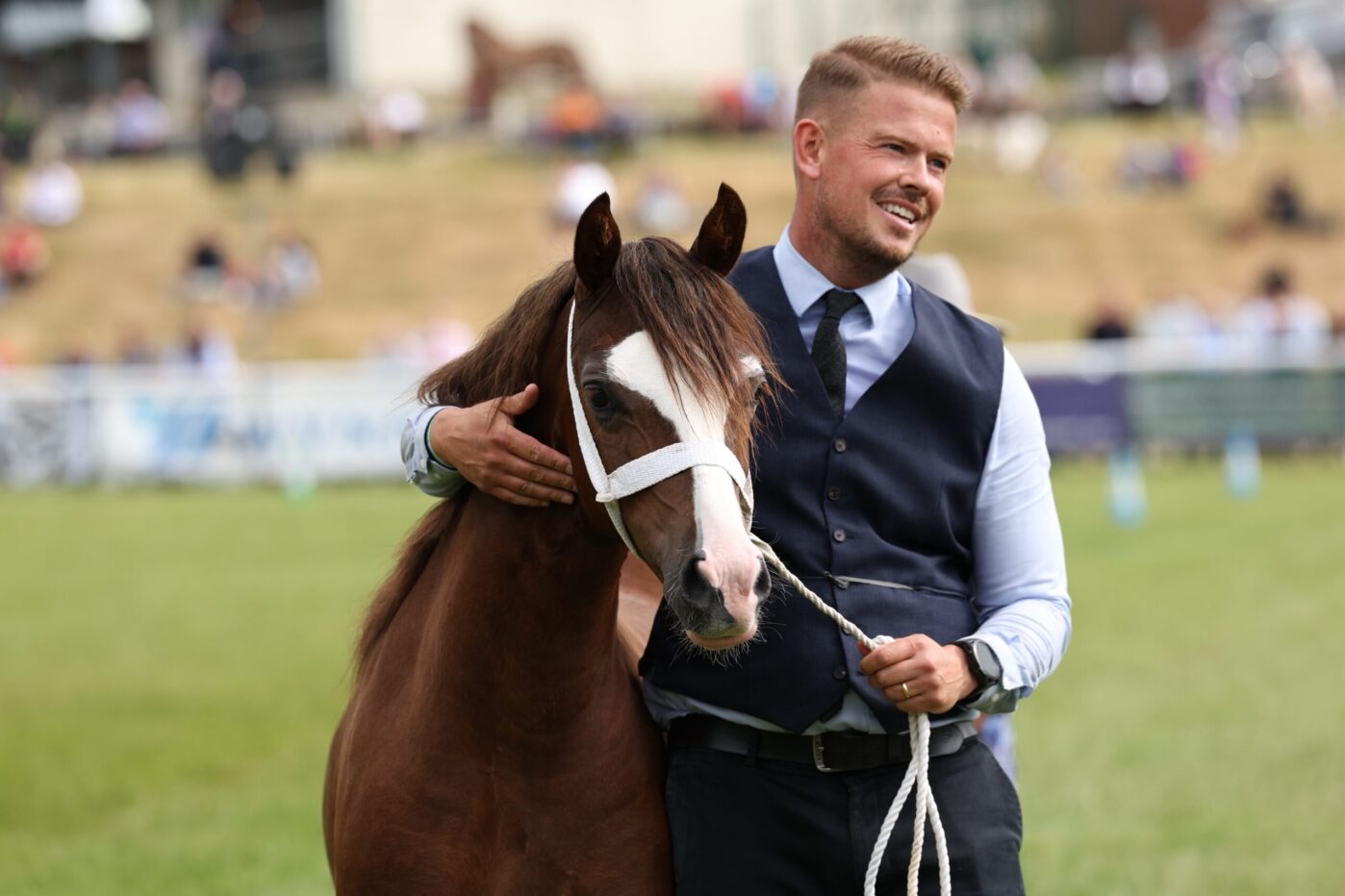 David Newsome gives Coppathorne Glitz and Glamour a hug after an above and beyond act of sportsmanship helped the pair win the section C yearling filly class at the Royal Welsh