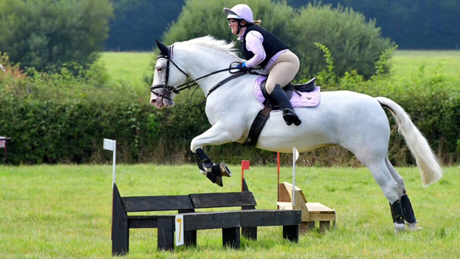 Franchesca jumping cross-country jump, with horse wearing Lemieux MIMsafe Cross Country boots