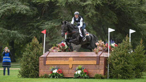 Germany's Jérôme Robiné and Black Ice clear a large wooden chest at the Blenheim European Eventing Championships 2025.
