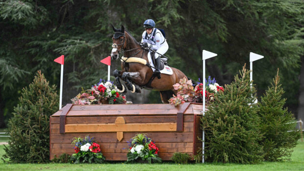 Laura Collett and London 52 jump boldy over a large wooden chest fence on the Blenheim Europeans cross-country course