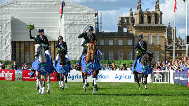 The four riders representing Germany salute the crowd on their lap of honour with Blenheim Palace in the background