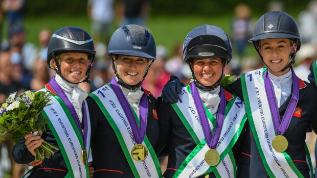 Ros Canter, Laura Collett, Kitty King and Yasmin Ingham celebrate their team gold medals on the podium at the 2023 European Eventing Championships.