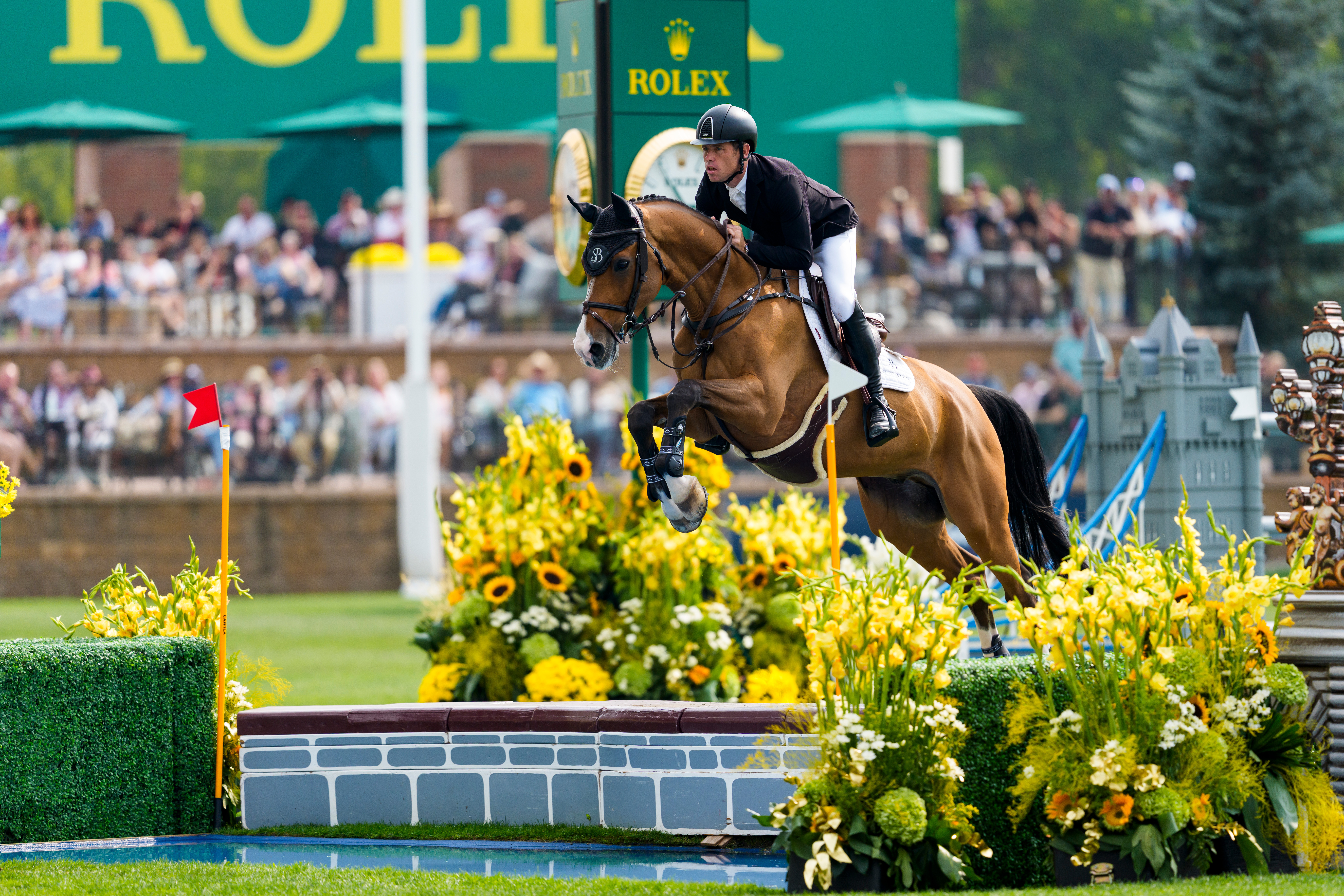 Scott Brash and Hello Jefferson clear Spruce Meadows' distinctive water jump.